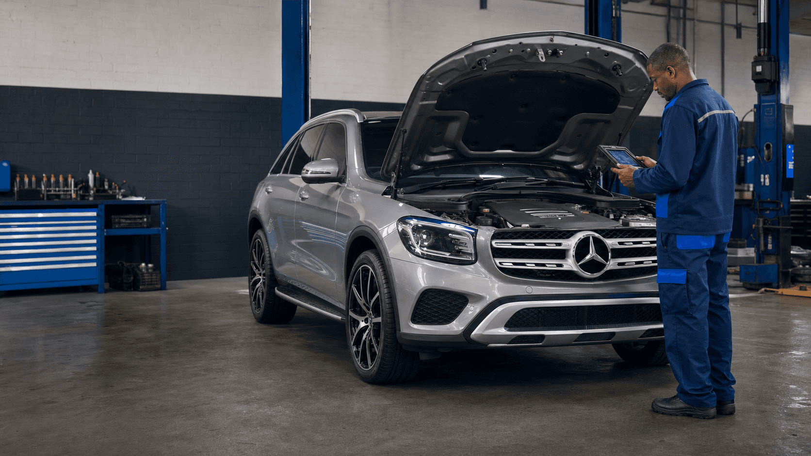 Technician performing vehicle diagnostics in the Zivot Mercedes workshop